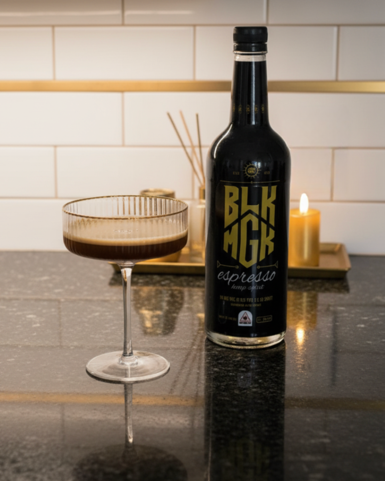 espresso martini next to bottle of BLK MGK in a modern kitchen with candle and diffuser in the background